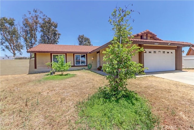 12642 Gorham St, Moreno Valley, CA 92553 - ranch-style house featuring a tile roof, a garage, concrete driveway, and stucco siding