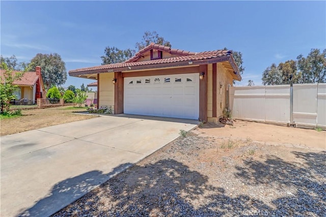 12642 Gorham St, Moreno Valley, CA 92553 - view of front facade with a tile roof, a garage, driveway, and stucco siding