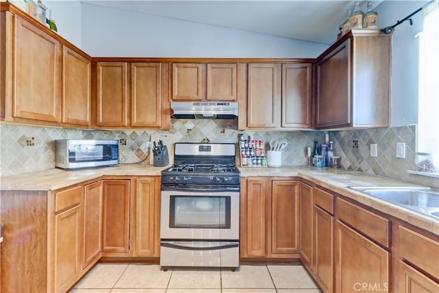 12642 Gorham St, Moreno Valley, CA 92553 - kitchen with stainless steel appliances, under cabinet range hood, light countertops, and vaulted ceiling