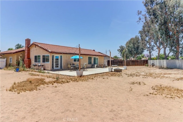 12642 Gorham St, Moreno Valley, CA 92553 - back of property with stucco siding, a patio area, a chimney, and a tiled roof