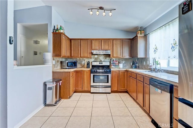 12642 Gorham St, Moreno Valley, CA 92553 - kitchen with stainless steel appliances, under cabinet range hood, lofted ceiling, light countertops, and tasteful backsplash