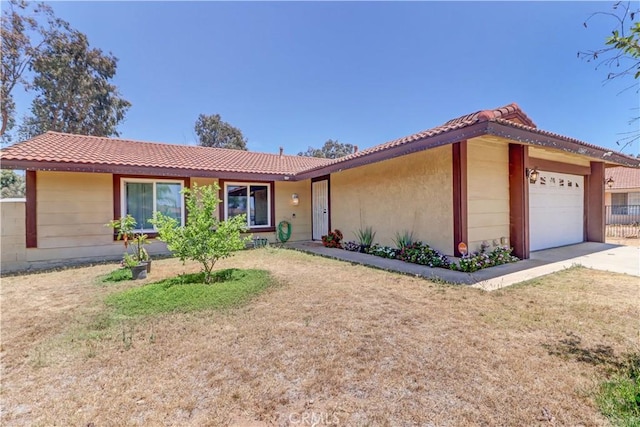 12642 Gorham St, Moreno Valley, CA 92553 - ranch-style home with an attached garage, a tile roof, concrete driveway, and a front lawn
