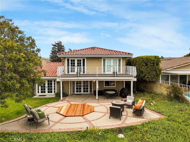 27990 Beechgate Dr, Rancho Palos Verdes, CA 90275 - rear view of property featuring french doors, a patio area, a tile roof, stucco siding, and a fire pit