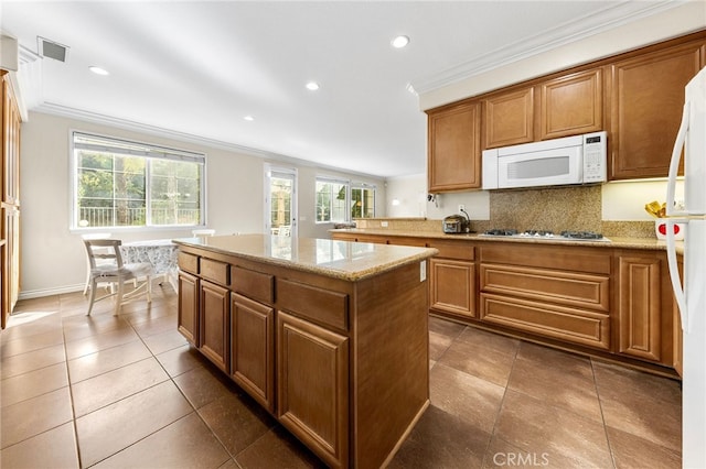 16848 Morning Glory Ct, Chino Hills, CA 91709 - kitchen with white appliances, ornamental molding, a center island, tasteful backsplash, and brown cabinetry