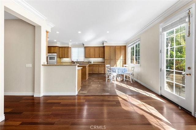 16848 Morning Glory Ct, Chino Hills, CA 91709 - kitchen with ornamental molding, brown cabinets, healthy amount of natural light, dark wood-style floors, and baseboards