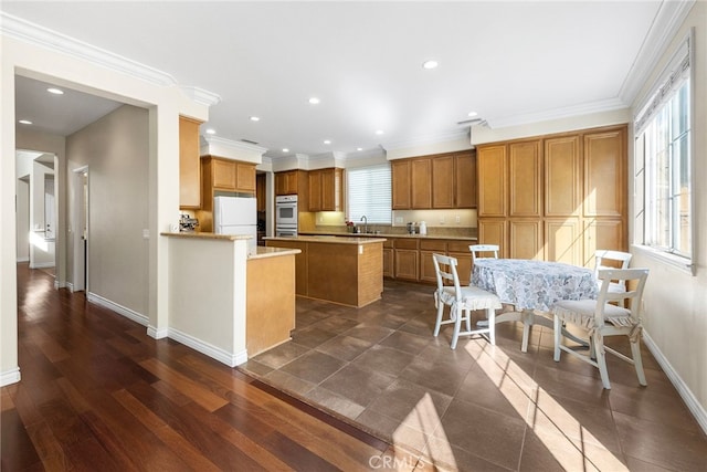 16848 Morning Glory Ct, Chino Hills, CA 91709 - kitchen with freestanding refrigerator, stainless steel double oven, a kitchen island, brown cabinets, and a sink