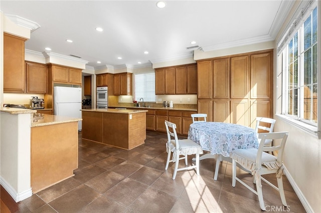 16848 Morning Glory Ct, Chino Hills, CA 91709 - kitchen with freestanding refrigerator, double oven, brown cabinets, a center island, and recessed lighting