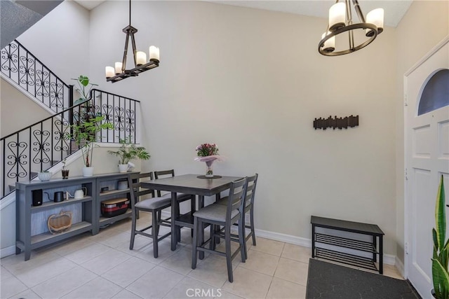 1844 W Falmouth Ave Unit 5, Anaheim, CA 92801 - tiled dining space with a chandelier, stairs, baseboards, and a towering ceiling