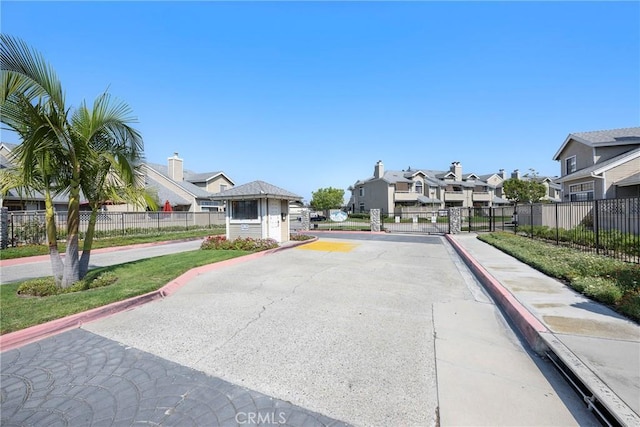 1844 W Falmouth Ave Unit 5, Anaheim, CA 92801 - view of asphalt road with a residential view, curbs, sidewalks, and a gated entry