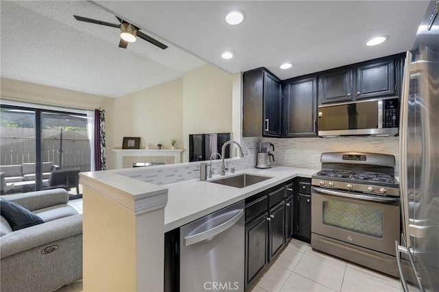 1844 W Falmouth Ave Unit 5, Anaheim, CA 92801 - kitchen with appliances with stainless steel finishes, a sink, backsplash, light tile patterned floors, and light countertops