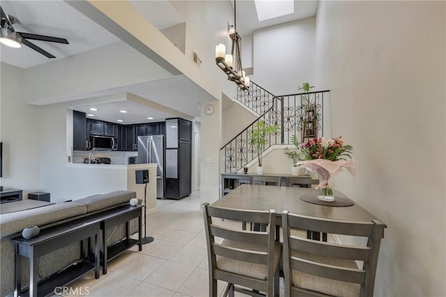 1844 W Falmouth Ave Unit 5, Anaheim, CA 92801 - dining space with stairs, light tile patterned flooring, a skylight, a ceiling fan, and a high ceiling