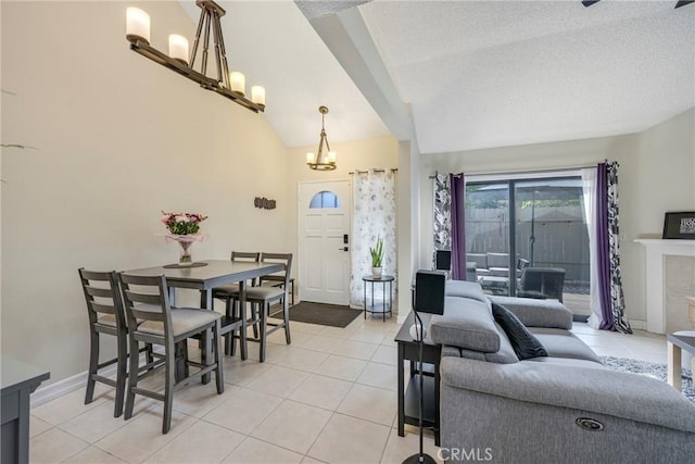 1844 W Falmouth Ave Unit 5, Anaheim, CA 92801 - living area featuring a chandelier, light tile patterned flooring, a textured ceiling, baseboards, and lofted ceiling