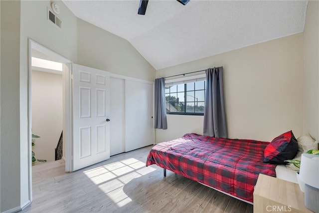 1844 W Falmouth Ave Unit 5, Anaheim, CA 92801 - bedroom featuring a textured ceiling, wood finished floors, lofted ceiling, a closet, and a ceiling fan