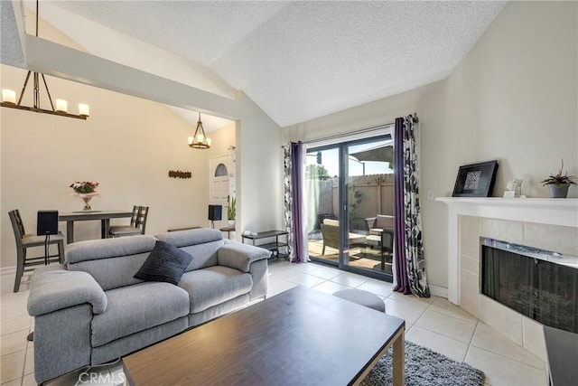 1844 W Falmouth Ave Unit 5, Anaheim, CA 92801 - living room featuring lofted ceiling, a chandelier, a fireplace, light tile patterned floors, and baseboards