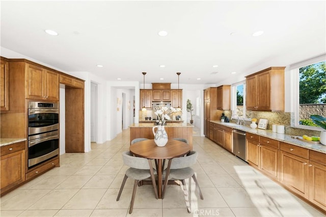 20010 Livorno Ln, Yorba Linda, CA 92886 - kitchen with stainless steel appliances, brown cabinetry, decorative backsplash, light stone counters, and recessed lighting
