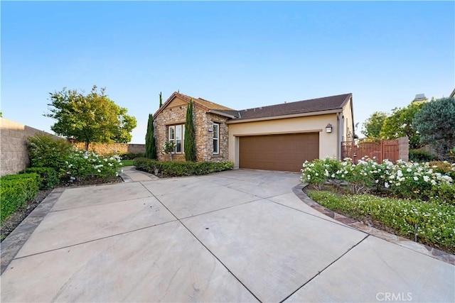 20010 Livorno Ln, Yorba Linda, CA 92886 - view of front of property with stone siding, driveway, an attached garage, and stucco siding