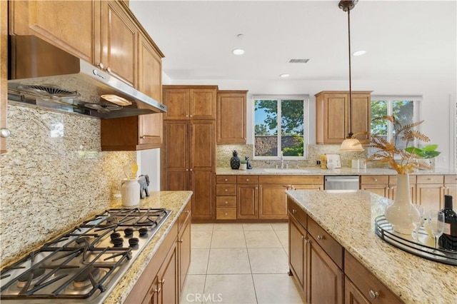 20010 Livorno Ln, Yorba Linda, CA 92886 - kitchen featuring appliances with stainless steel finishes, under cabinet range hood, a sink, decorative backsplash, and brown cabinetry