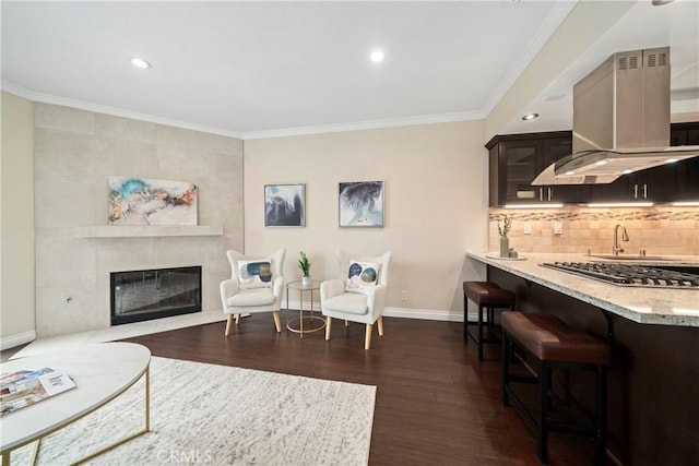 1845 Plaza Del Amo Unit C, Torrance, CA 90501 - living room featuring dark wood-style flooring, crown molding, a fireplace, and recessed lighting