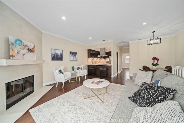 1845 Plaza Del Amo Unit C, Torrance, CA 90501 - living area featuring dark wood-type flooring, a chandelier, recessed lighting, a fireplace, and crown molding