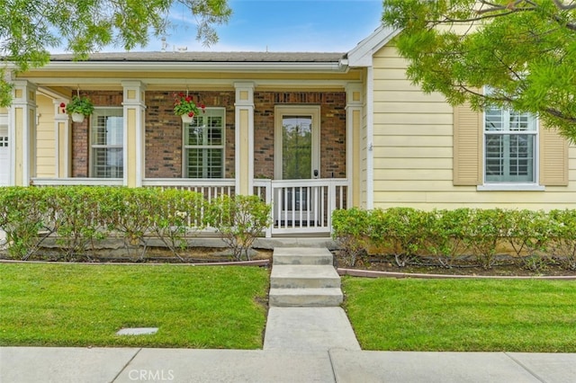 28978 Williston Ct, Temecula, CA 92591 - view of exterior entry featuring covered porch, a lawn, and brick siding