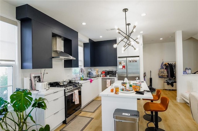 137 Saint Francis St Unit A, San Gabriel, CA 91776 - kitchen featuring appliances with stainless steel finishes, wall chimney range hood, dark cabinetry, light countertops, and recessed lighting