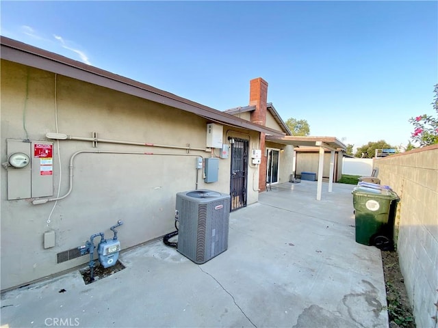 743 N Beechwood Ave, Rialto, CA 92376 - view of side of property featuring a patio, a chimney, and stucco siding