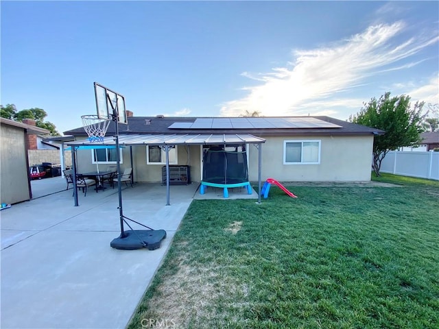 743 N Beechwood Ave, Rialto, CA 92376 - rear view of property with solar panels, a patio area, a fenced backyard, and stucco siding