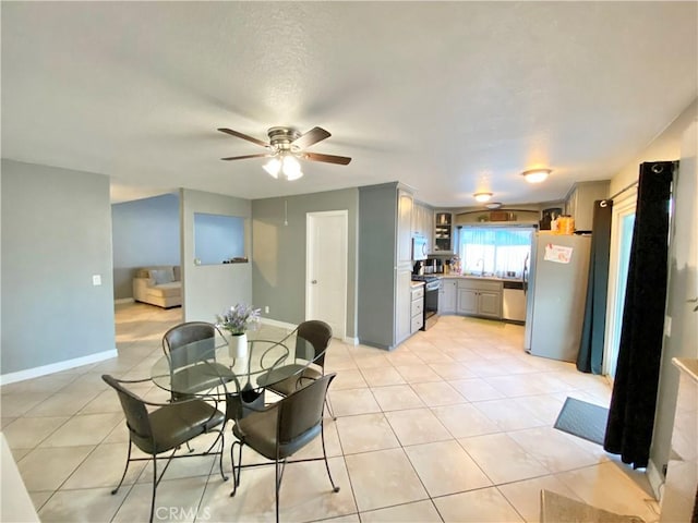 743 N Beechwood Ave, Rialto, CA 92376 - dining room with ceiling fan and light tile patterned flooring