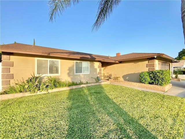 743 N Beechwood Ave, Rialto, CA 92376 - ranch-style home featuring stucco siding, a front lawn, and an attached garage