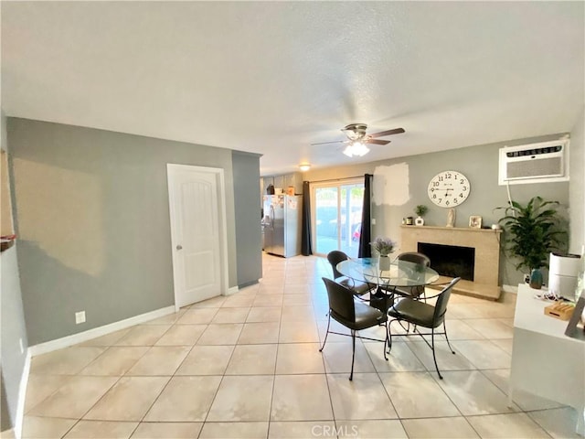 743 N Beechwood Ave, Rialto, CA 92376 - dining space featuring ceiling fan, an AC wall unit, a fireplace, and light tile patterned floors