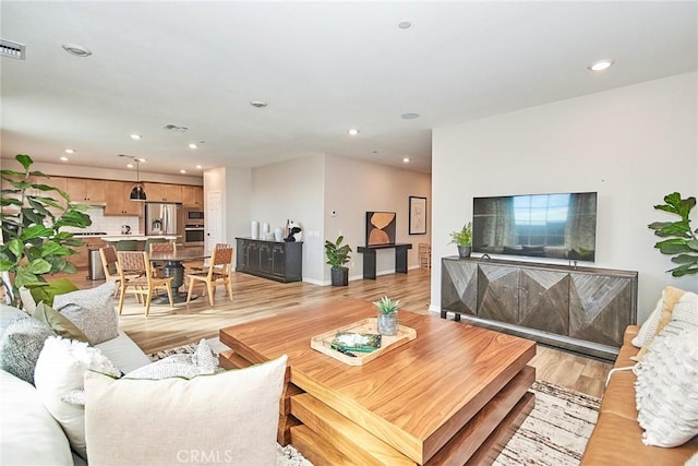 3430 E Foxglove Way, Ontario, CA 91761 - living room with light wood-style flooring, recessed lighting, and baseboards