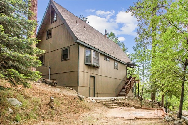6429 Cedar Ave, Angelus Oaks, CA 92305 - view of side of home featuring stairs and roof with shingles