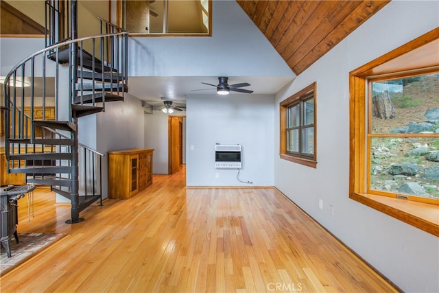 6429 Cedar Ave, Angelus Oaks, CA 92305 - unfurnished living room featuring heating unit, ceiling fan, stairway, wood-type flooring, and high vaulted ceiling