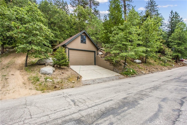6429 Cedar Ave, Angelus Oaks, CA 92305 - view of front of house featuring a garage and concrete driveway