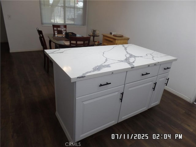 1676 Dumbarton Ave, San Bernardino, CA 92404 - kitchen featuring dark wood-style floors, a center island, and light stone countertops