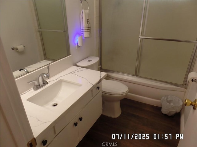 1676 Dumbarton Ave, San Bernardino, CA 92404 - bathroom with vanity, wood finished floors, and bath / shower combo with glass door