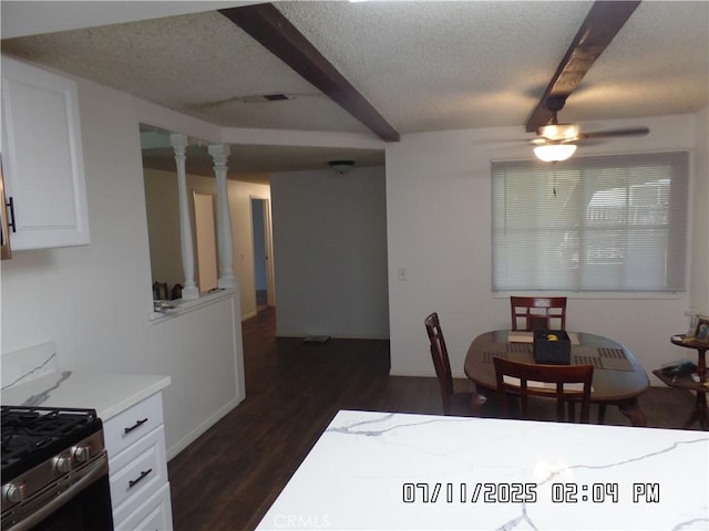 1676 Dumbarton Ave, San Bernardino, CA 92404 - dining space featuring a textured ceiling, dark wood finished floors, a ceiling fan, beam ceiling, and ornate columns