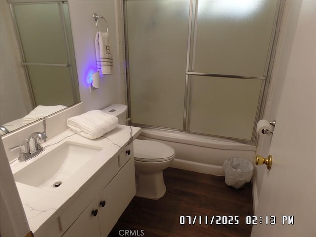 1676 Dumbarton Ave, San Bernardino, CA 92404 - full bath featuring vanity, wood finished floors, and bath / shower combo with glass door