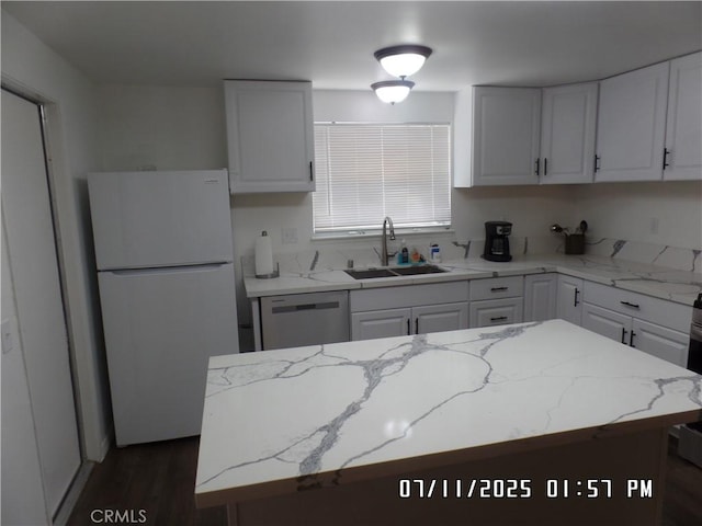 1676 Dumbarton Ave, San Bernardino, CA 92404 - kitchen with freestanding refrigerator, dishwasher, white cabinetry, dark wood-style floors, and light stone counters