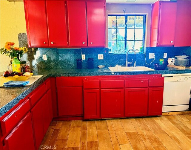 15994 Cactus St, Hesperia, CA 92345 - kitchen featuring red cabinetry, dishwasher, a sink, light wood-style flooring, and decorative backsplash