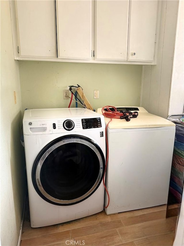 15994 Cactus St, Hesperia, CA 92345 - laundry area featuring light wood-style flooring, cabinet space, and washing machine and dryer