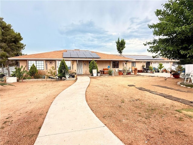 15994 Cactus St, Hesperia, CA 92345 - view of front of home featuring solar panels and stucco siding