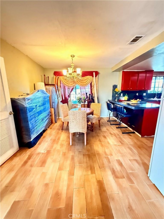 15994 Cactus St, Hesperia, CA 92345 - dining room featuring a chandelier and light wood finished floors