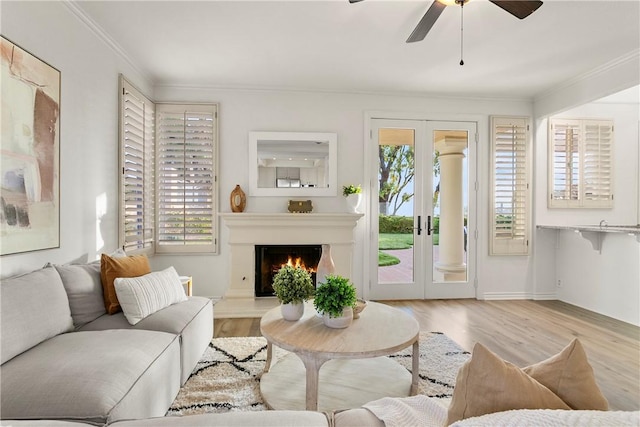 11 Porto Cervo Dr, Dana Point, CA 92629 - living room featuring ornamental molding, wood finished floors, ceiling fan, and a lit fireplace