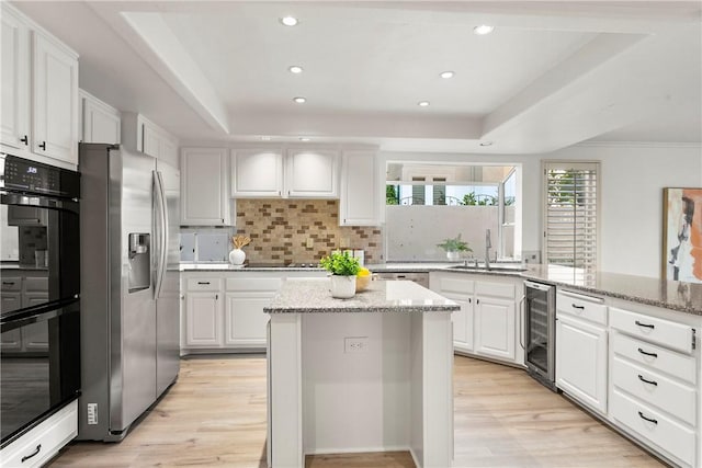 11 Porto Cervo Dr, Dana Point, CA 92629 - kitchen featuring black appliances, beverage cooler, white cabinetry, light wood finished floors, and recessed lighting