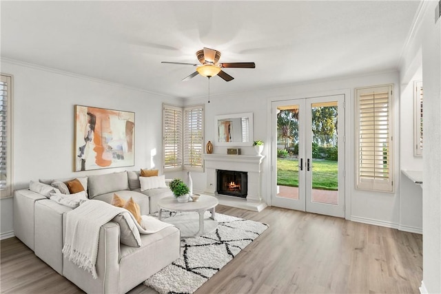 11 Porto Cervo Dr, Dana Point, CA 92629 - living area with a ceiling fan, healthy amount of natural light, light wood-style floors, ornamental molding, and a lit fireplace
