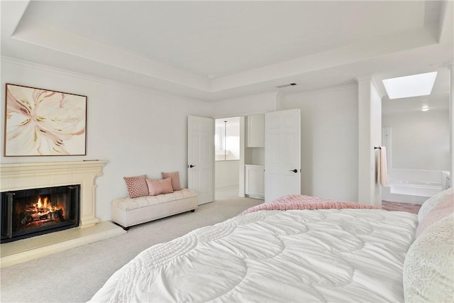11 Porto Cervo Dr, Dana Point, CA 92629 - carpeted bedroom with a tray ceiling, a glass covered fireplace, a skylight, and ensuite bath