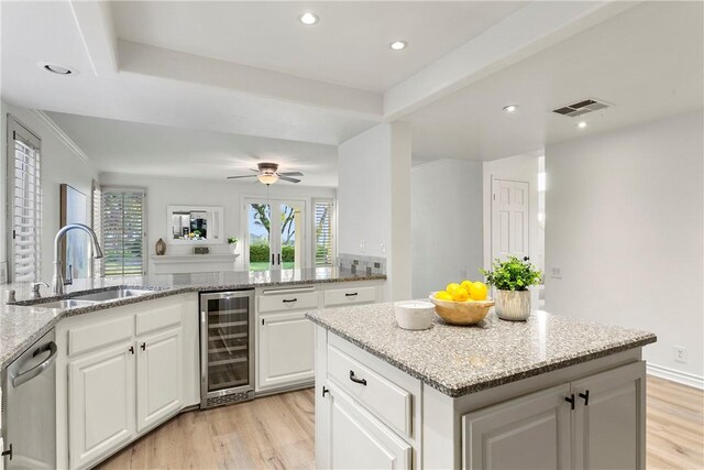 11 Porto Cervo Dr, Dana Point, CA 92629 - kitchen with wine cooler, light wood-style floors, dishwasher, white cabinets, and recessed lighting