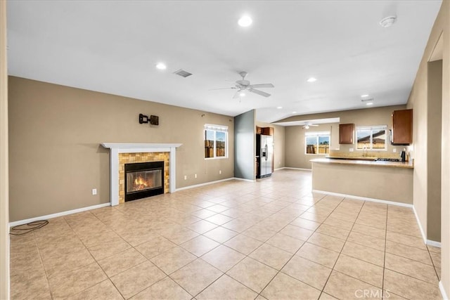 7415 Saladin Ave Unit 29, Palms, CA 92277 - unfurnished living room featuring ceiling fan, recessed lighting, light tile patterned floors, a tiled fireplace, and baseboards
