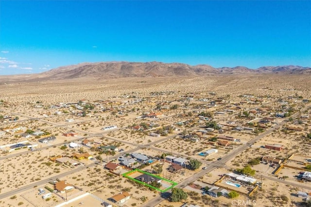 7415 Saladin Ave Unit 29, Palms, CA 92277 - aerial view of sparsely populated area featuring a desert landscape, property boundaries highlighted, and a mountain backdrop